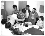 A nurse demonstrates how to listen for a baby's heartbeat for a group of individuals by Indiana State University, University Archives