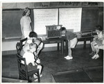 Children and teacher looking at bees in container by Indiana State University, University Archives