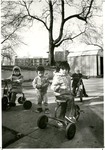 Children on tricycles at ISU Childcare center by Indiana State University, University Archives