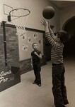 Kids play basketball inside school by Indiana State University, University Archives