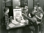 Teacher with Calendar and students in library by Indiana State University, University Archives