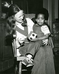 Toddler on woman's lap by Indiana State University, University Archives