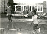 Two kids jumping by Indiana State University, University Archives