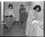 Students doing ironing in Erickson laundry room by Indiana State University