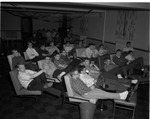 Students watching TV in Parsons Hall lounge by Indiana State University
